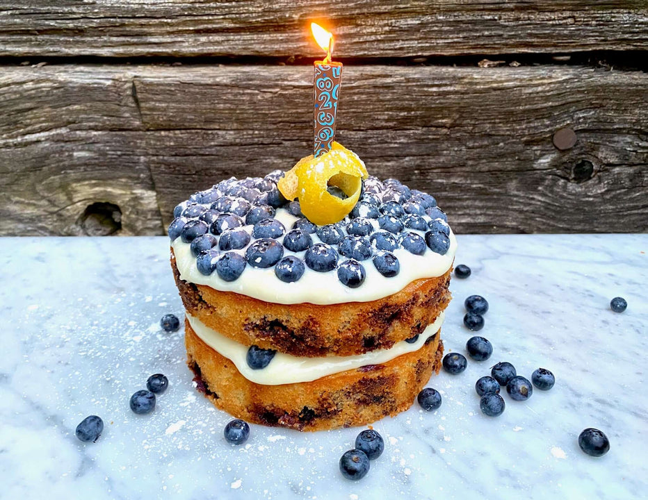 Edible Milk Chocolate Candle with blue numbers/stars on blueberry layer cake | Let Them Eat Candles