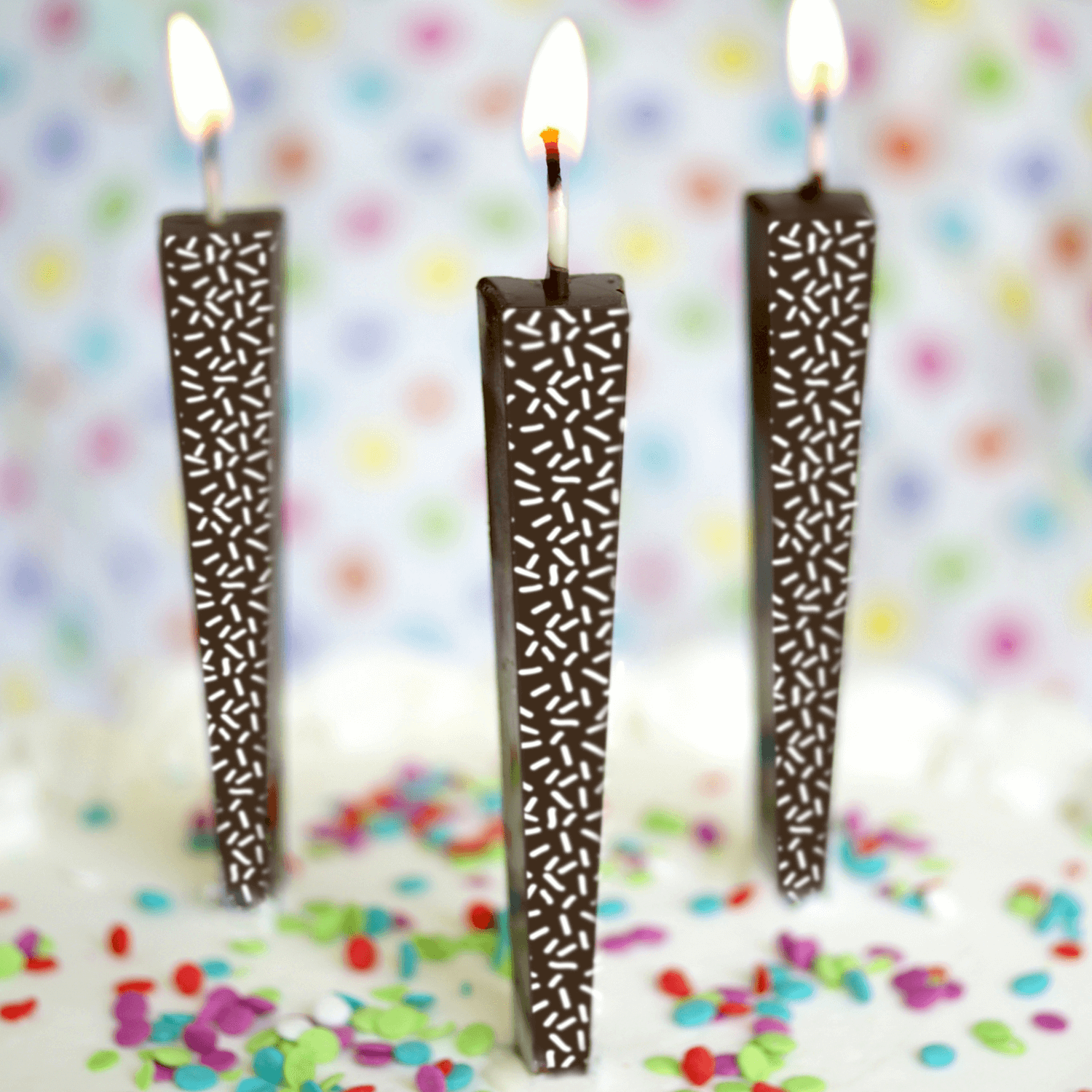 Edible Dark Chocolate Candles with white sprinkles on cake with sprinkles | Let Them Eat Candles