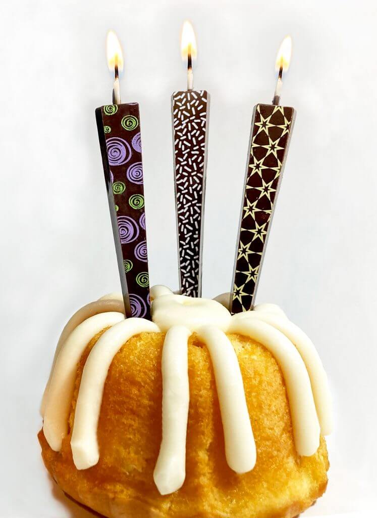 Variety of Edible Dark Chocolate Candles on mini Bundt cake | Let Them Eat Candles