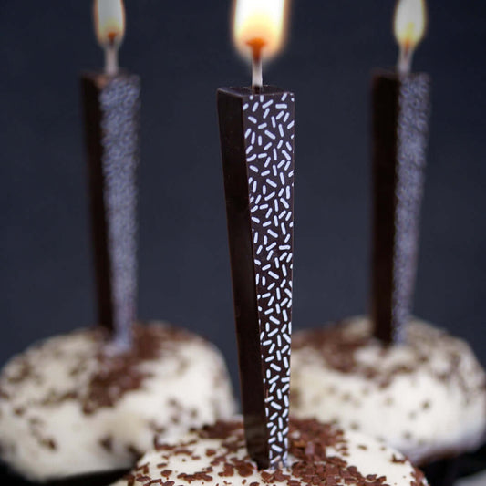 Edible Dark Chocolate Candles with white sprinkles on chocolate cupcakes | Let Them Eat Candles